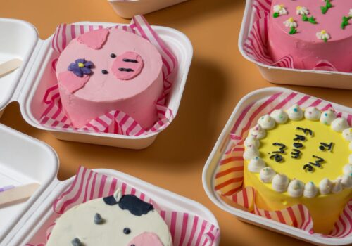 lots-little-colorful-cakes-boxes-orange-background-korean-lunch-box-cake